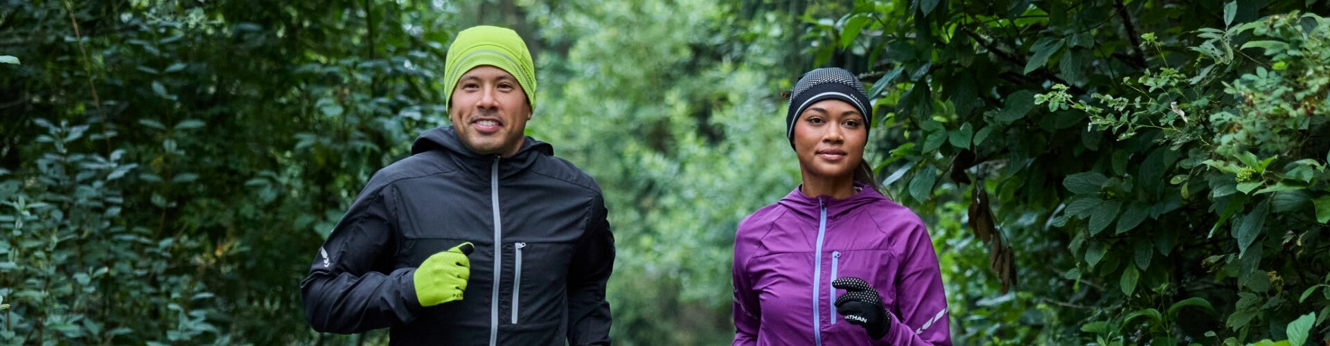 2 Runners Wearing Hats As They Jog Through the Forest